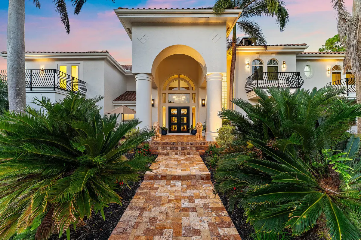 Grand Front Entry with Evening Glow at 2584 SE Ranch Acres Circle, Jupiter