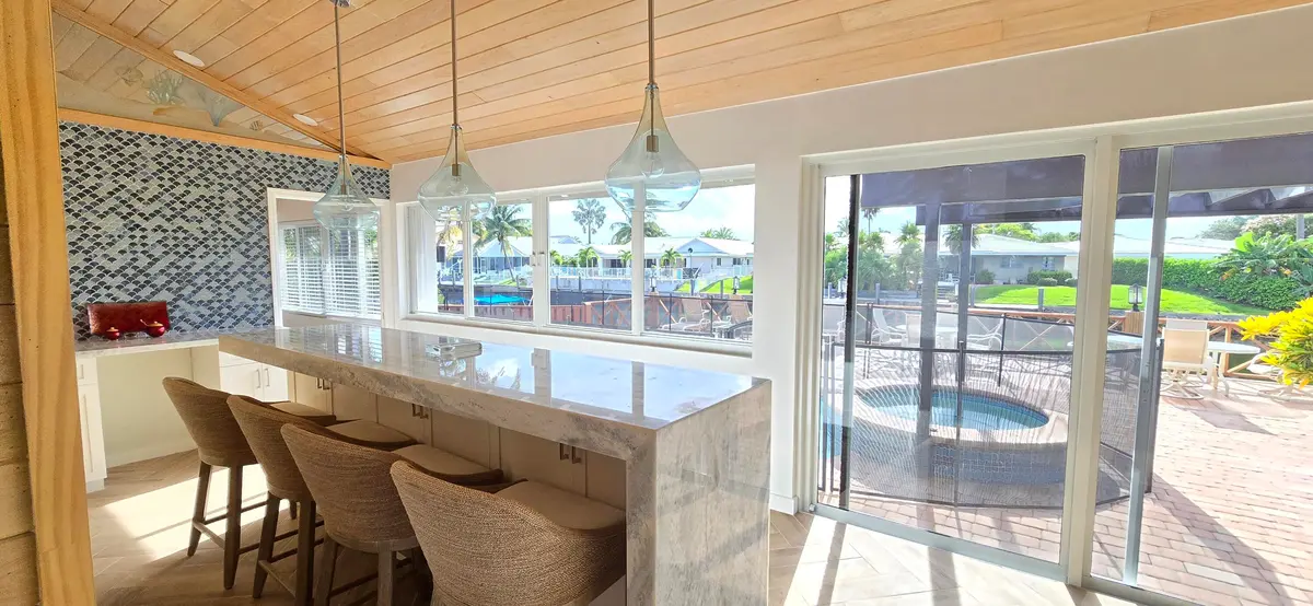 Waterfall bar overlooking pool & water at 4011 NE 27th Terrace, Lighthouse Point