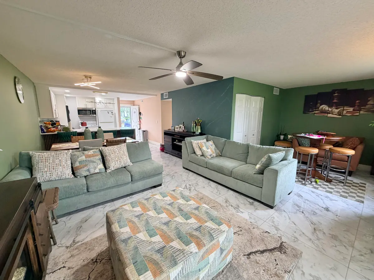 Living room to dining area to kitchen at 6161 NW 2nd Avenue 123, Boca Raton