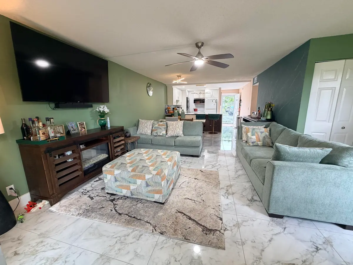 Living room to dining area to kitchen at 6161 NW 2nd Avenue 123, Boca Raton