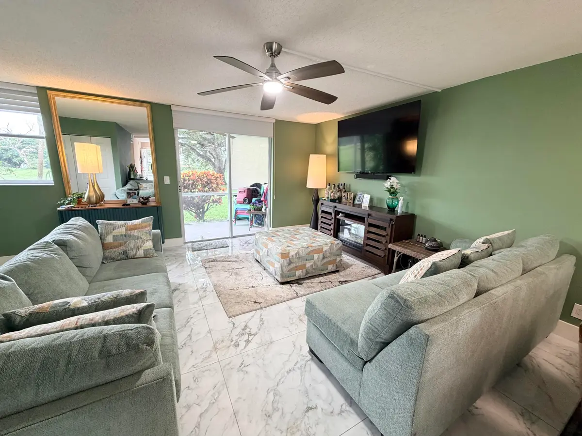 Living room to screened patio at 6161 NW 2nd Avenue 123, Boca Raton