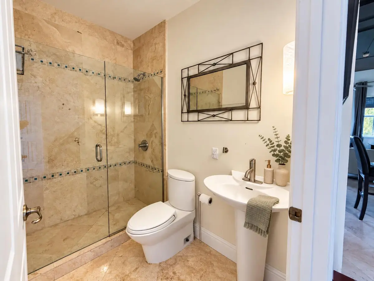 Warm organic bathroom accents at 301 W Atlantic Avenue L10, Delray Beach