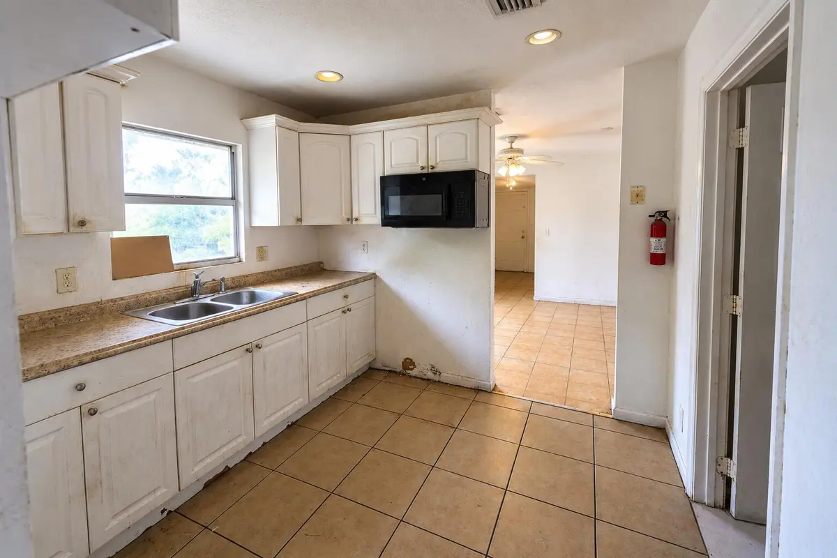 Kitchen with Sunlit Hallway at 11 S D Street, Lake Worth Beach