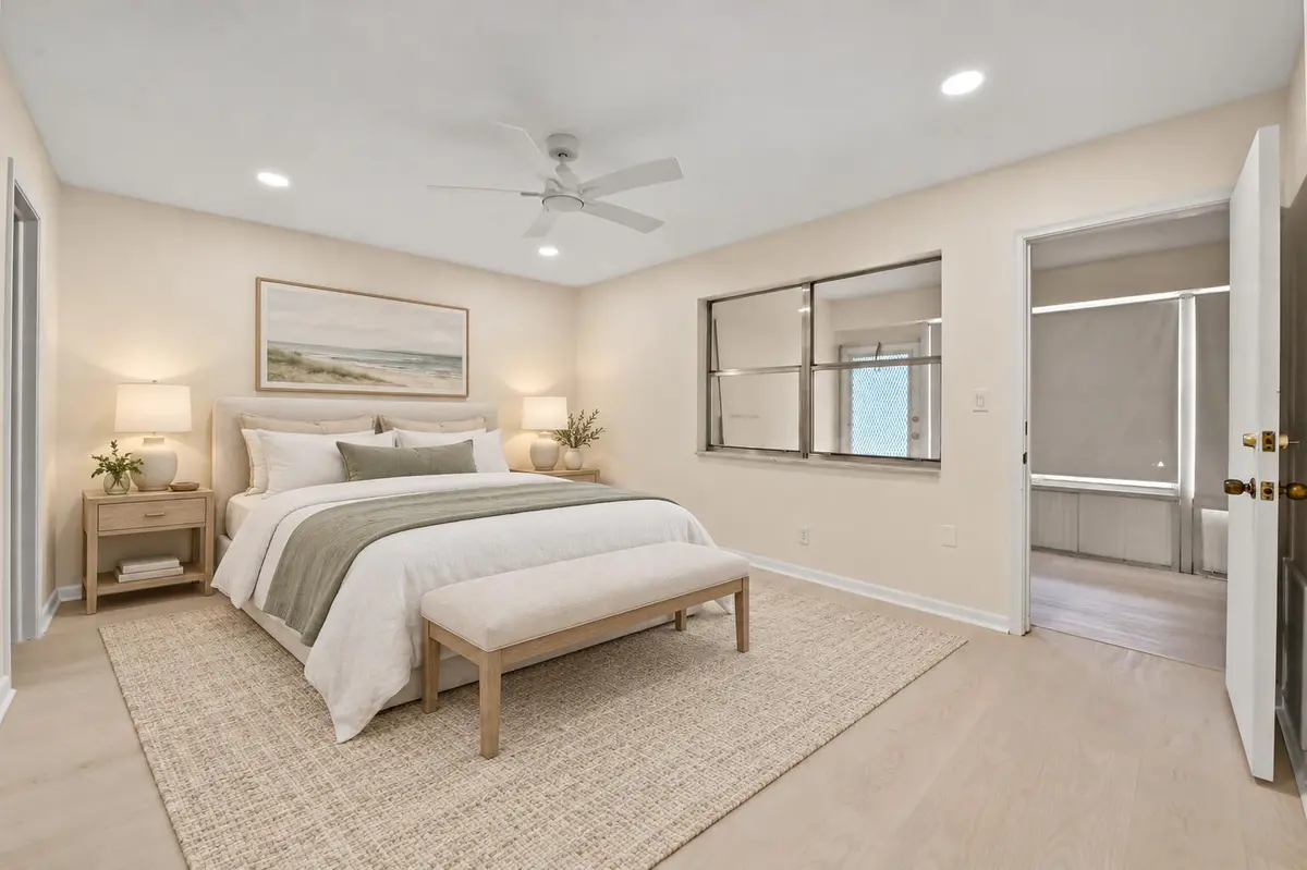 09 Primary Bedroom - Virtually Staged at 665 High Point Drive C, Delray Beach