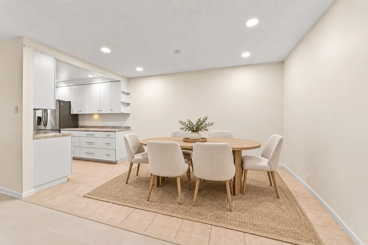Virtually staged coastal dining room at 665 High Point Drive C, Delray Beach