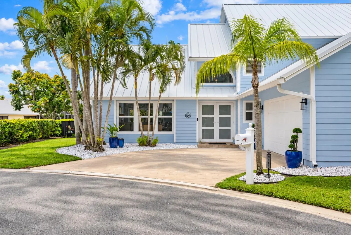 Coastal Blue Home with Tropical Landscap at 9029 SE Breeze Way, Hobe Sound