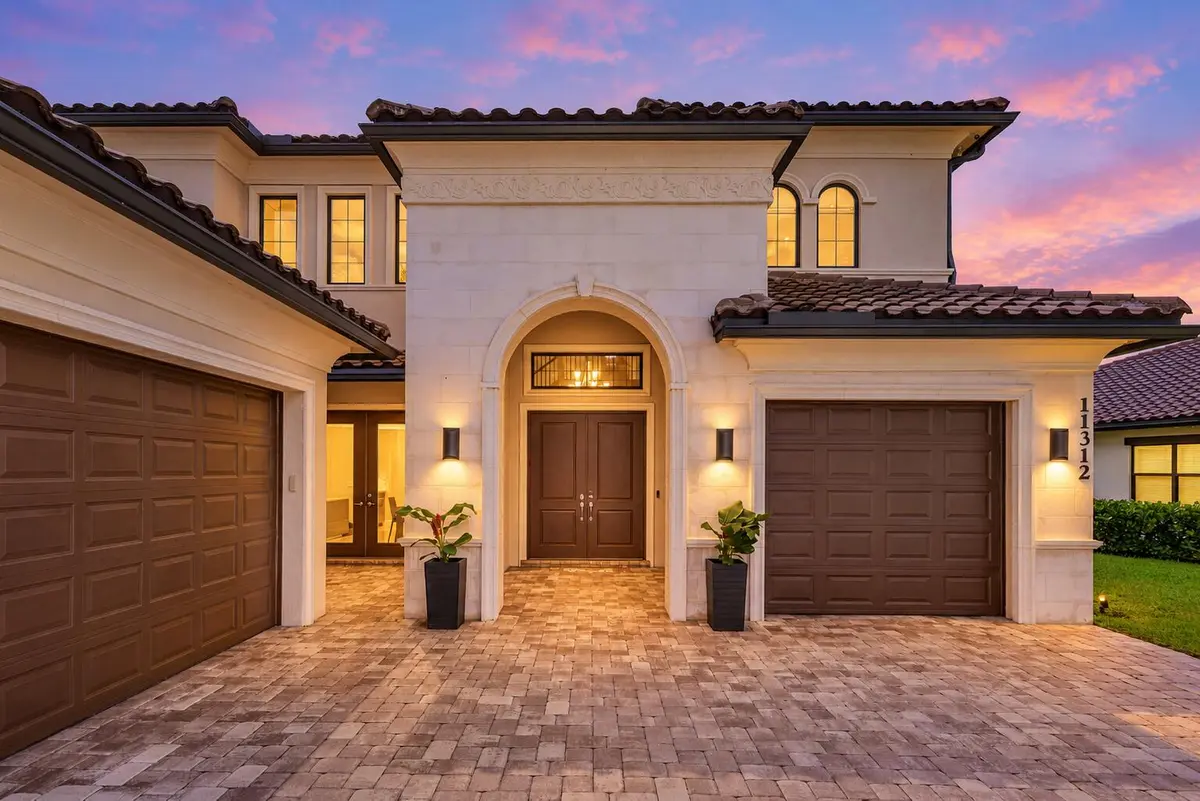 Warmly lit home at twilight at 11312 NW 81st Place, Parkland