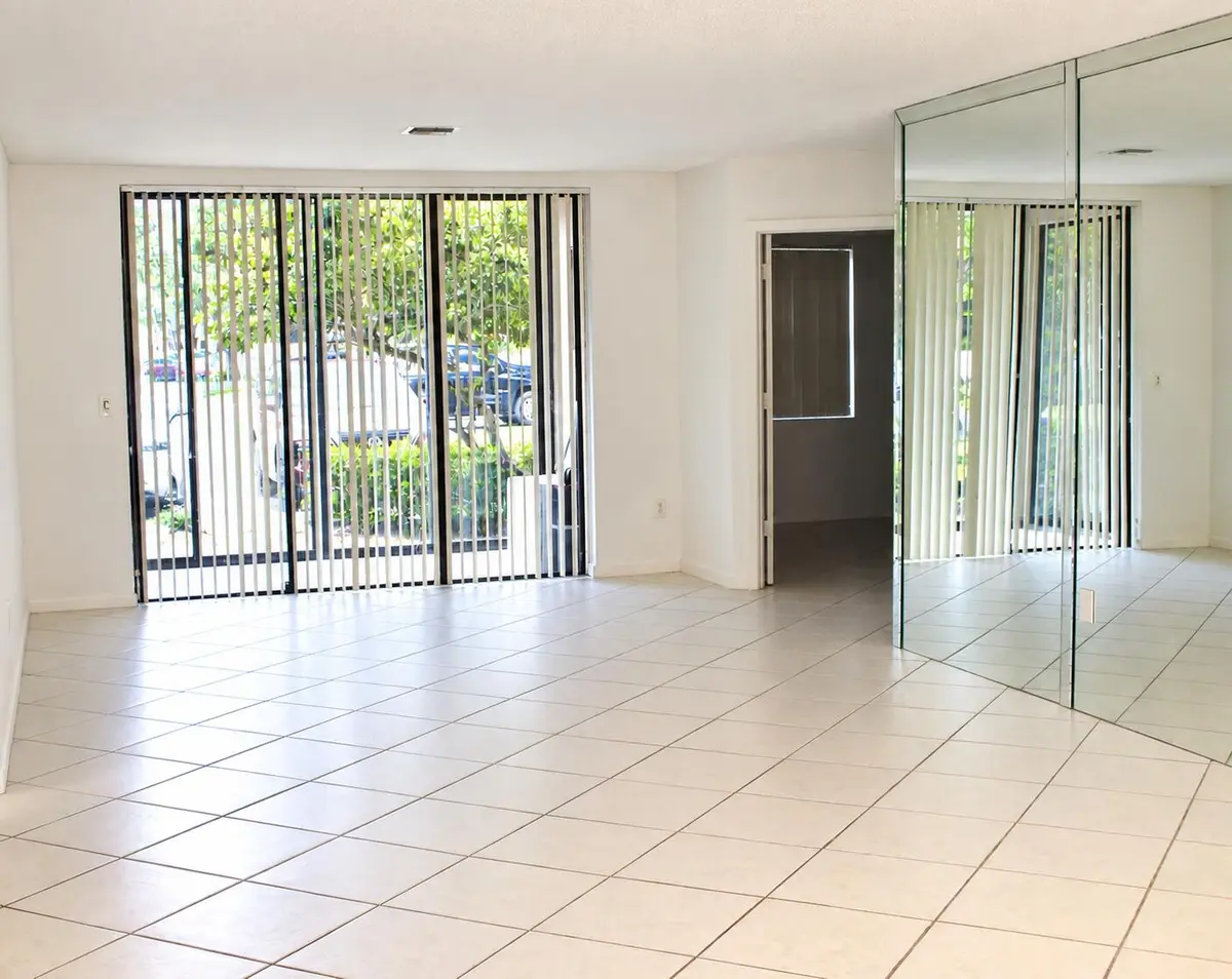 Bright Empty Living Room with Mirrored W at 4450 NW 30TH Street 111, Coconut Creek