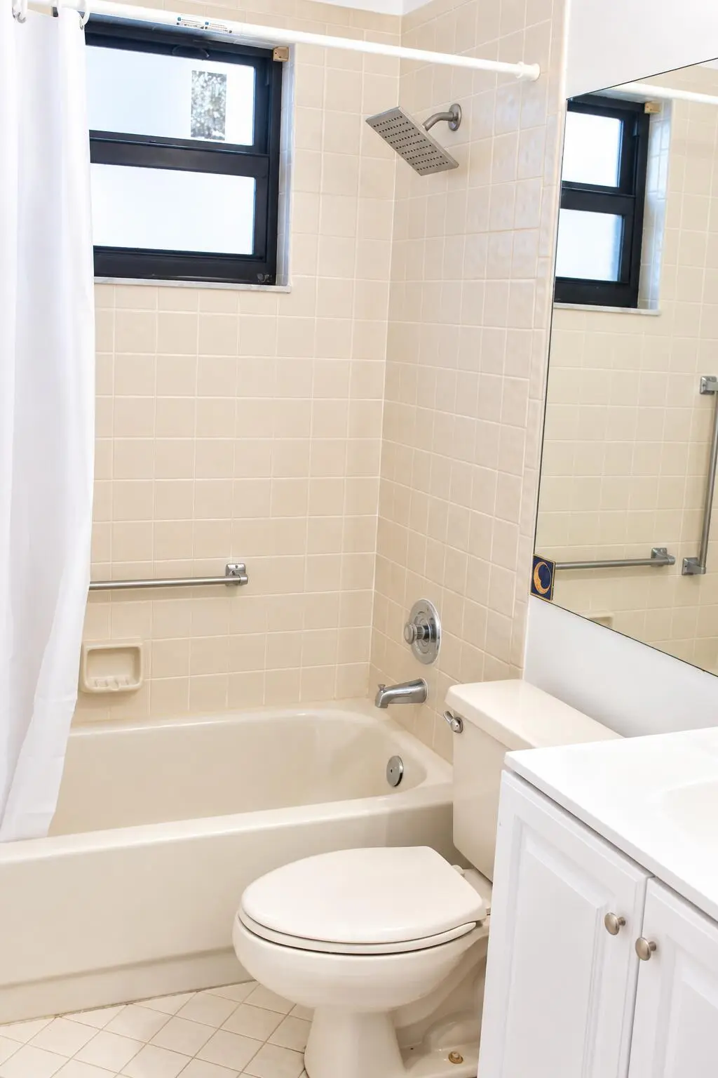 Bright Neutral Bathroom with Tub and Van at 4450 NW 30TH Street 111, Coconut Creek