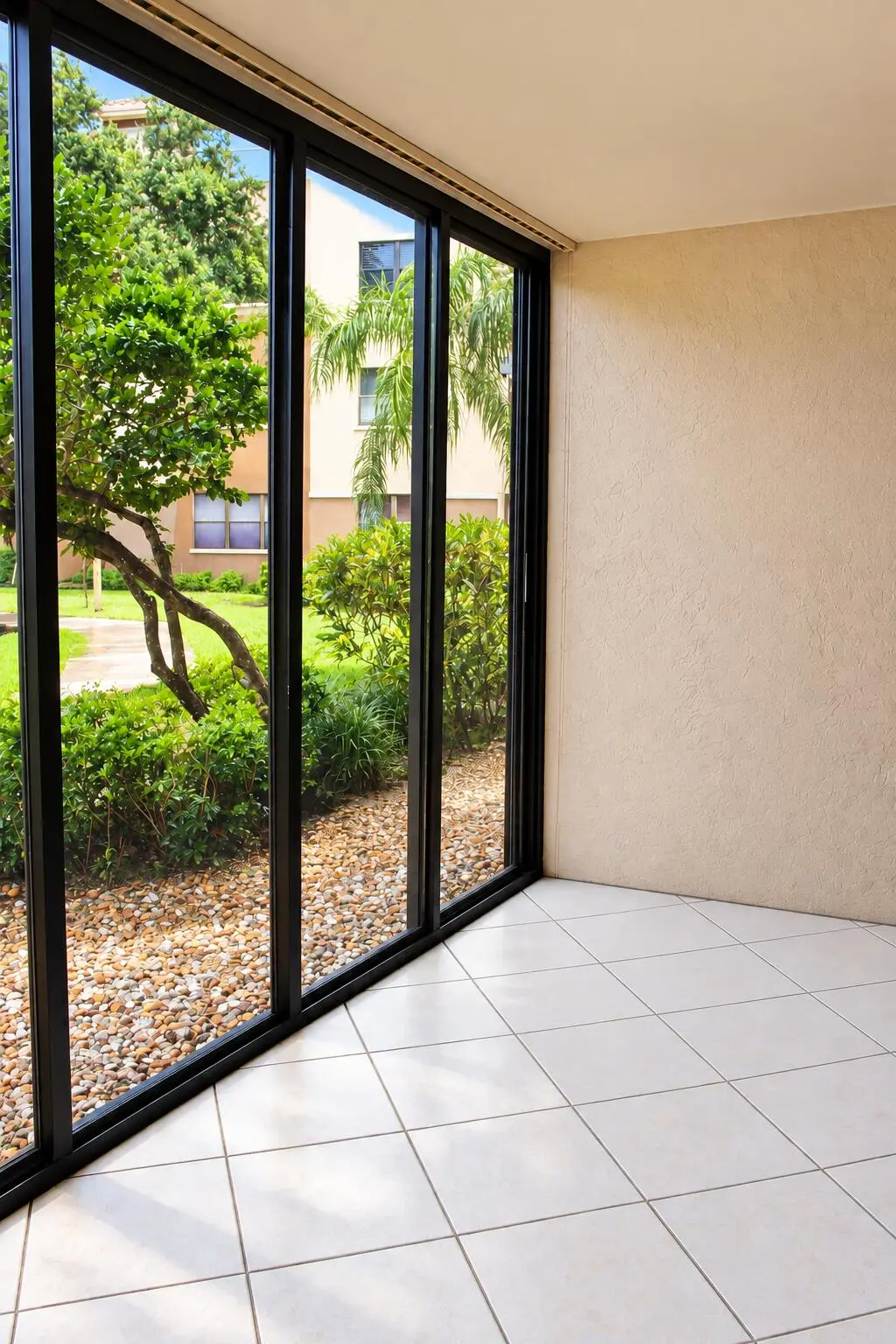 Sunlit Screened Patio with Garden Views at 4450 NW 30TH Street 111, Coconut Creek