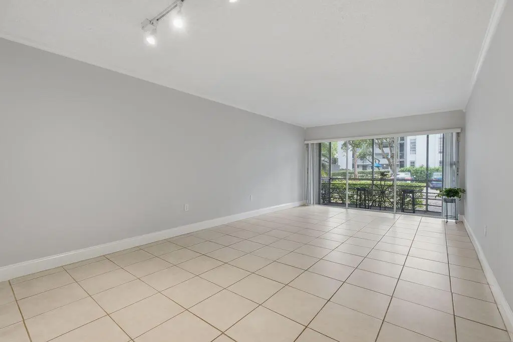 Travis living room looks to patio at 485 N PINE ISLAND Road A105, Plantation