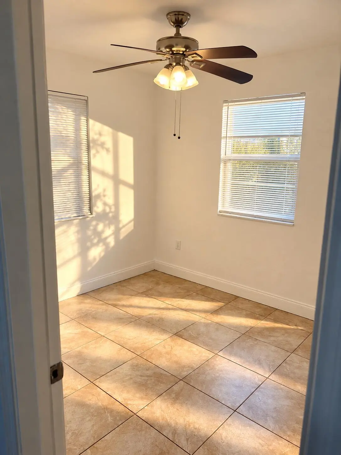 Sunlit Empty Room with Ceiling Fan at 5260 NE 16TH Avenue, Pompano Beach