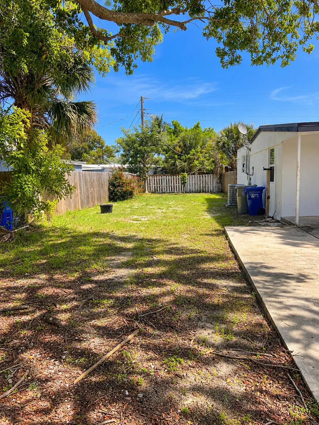 Sunny Tropical Backyard with Tree Shadow at 5260 NE 16TH Avenue, Pompano Beach