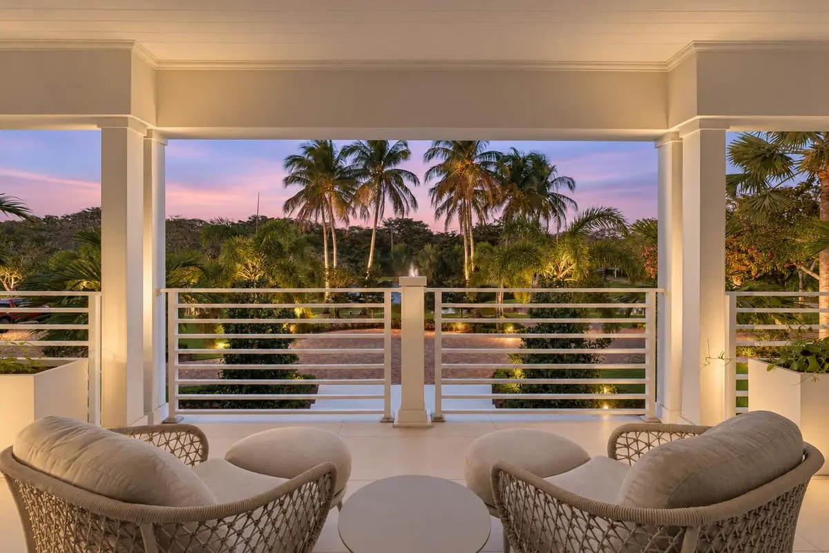 Twilight Porch with Palm-Lined Pond at 13920 Stirling Road, Southwest Ranches