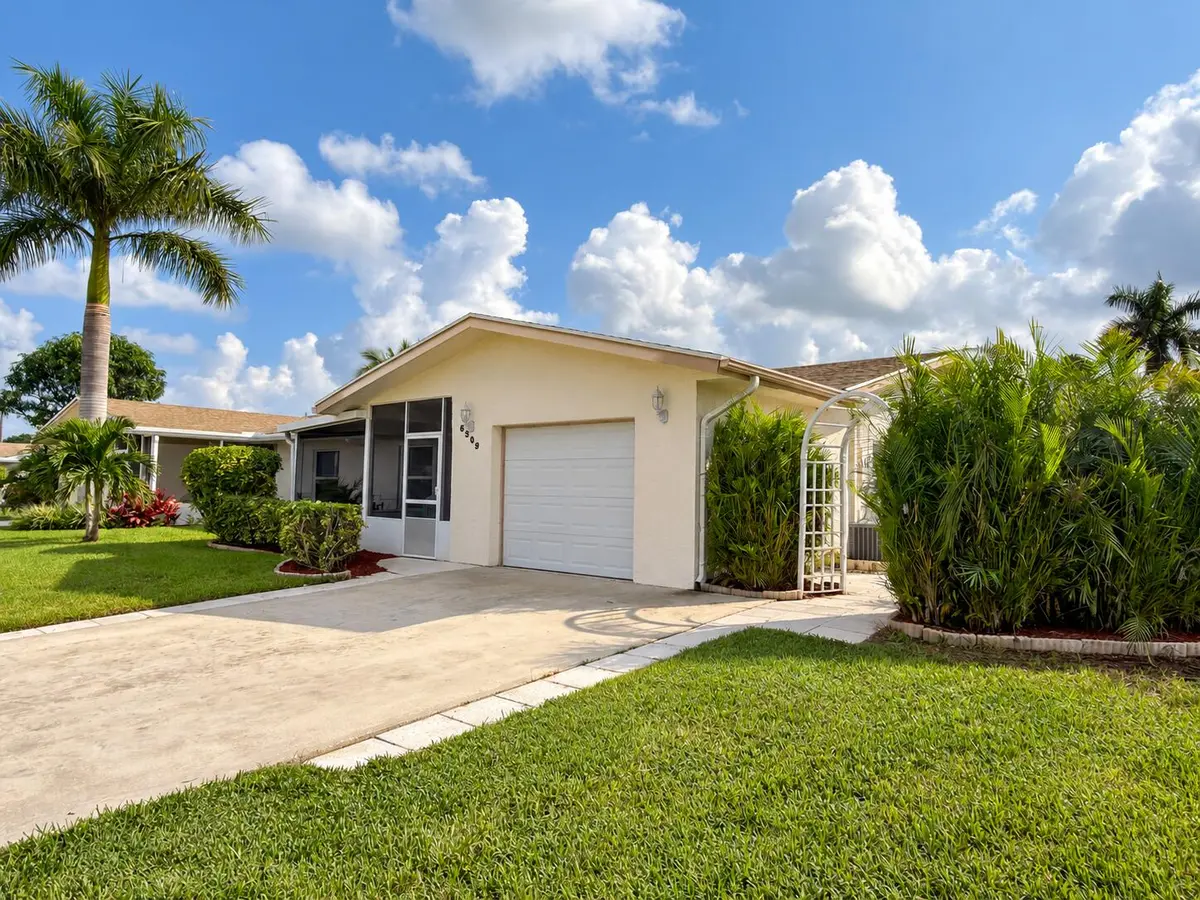 Sunlit cream home with screened porch at 6309 DUSENBURG Road, Delray Beach