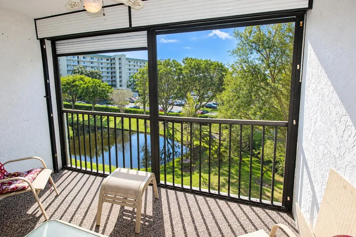 Balcony Overlooking Pond and Gardens at 2230 N CYPRESS BEND Drive 410, Pompano Beach