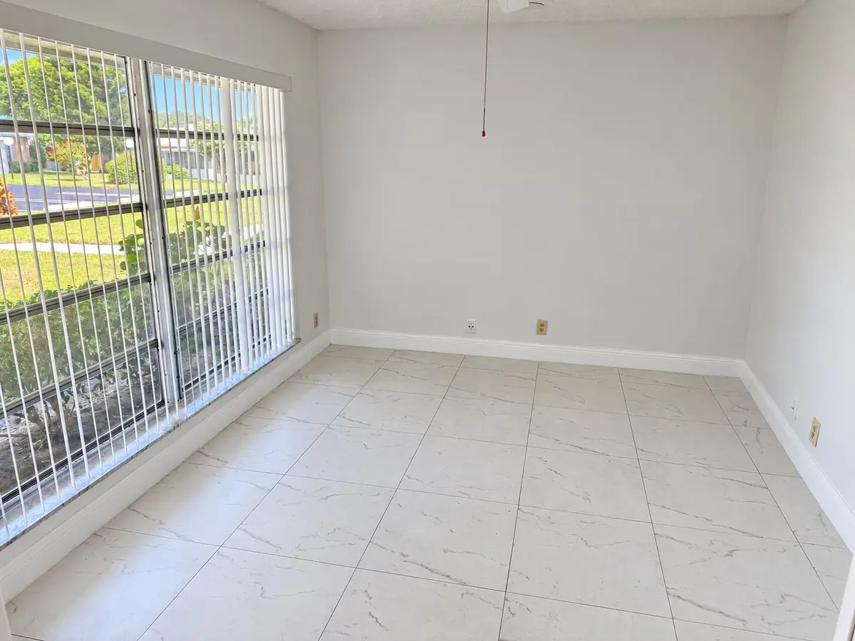 Bright Empty Room with Windowed Wall at 1120 LEMON TREE Terrace 73-C, Delray Beach