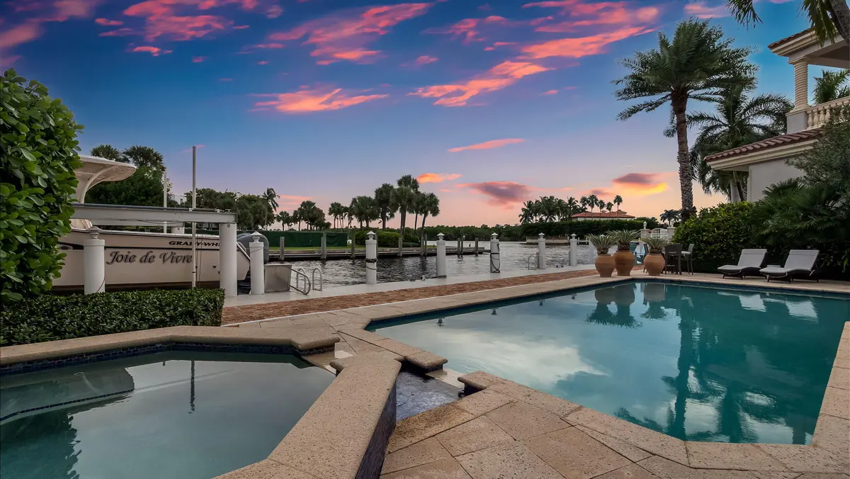 Intracoastal and pool view at dusk at 1014 Grand Court, Highland Beach