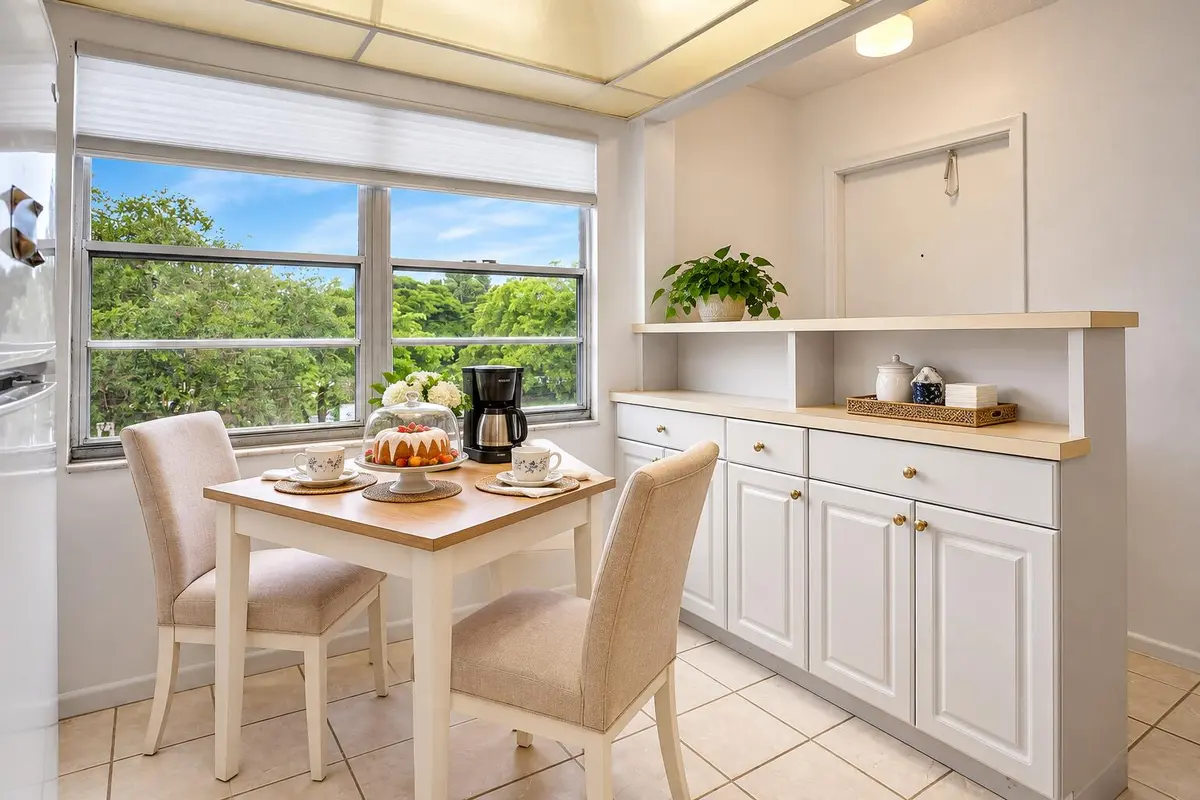 Cozy Breakfast Nook with Coffee and Cake at 3002 Portofino Isle M3, Coconut Creek