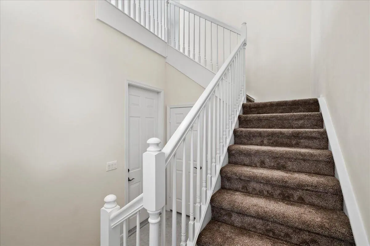 Staircase to Living Area at 107 Evergrene Parkway, Palm Beach Gardens