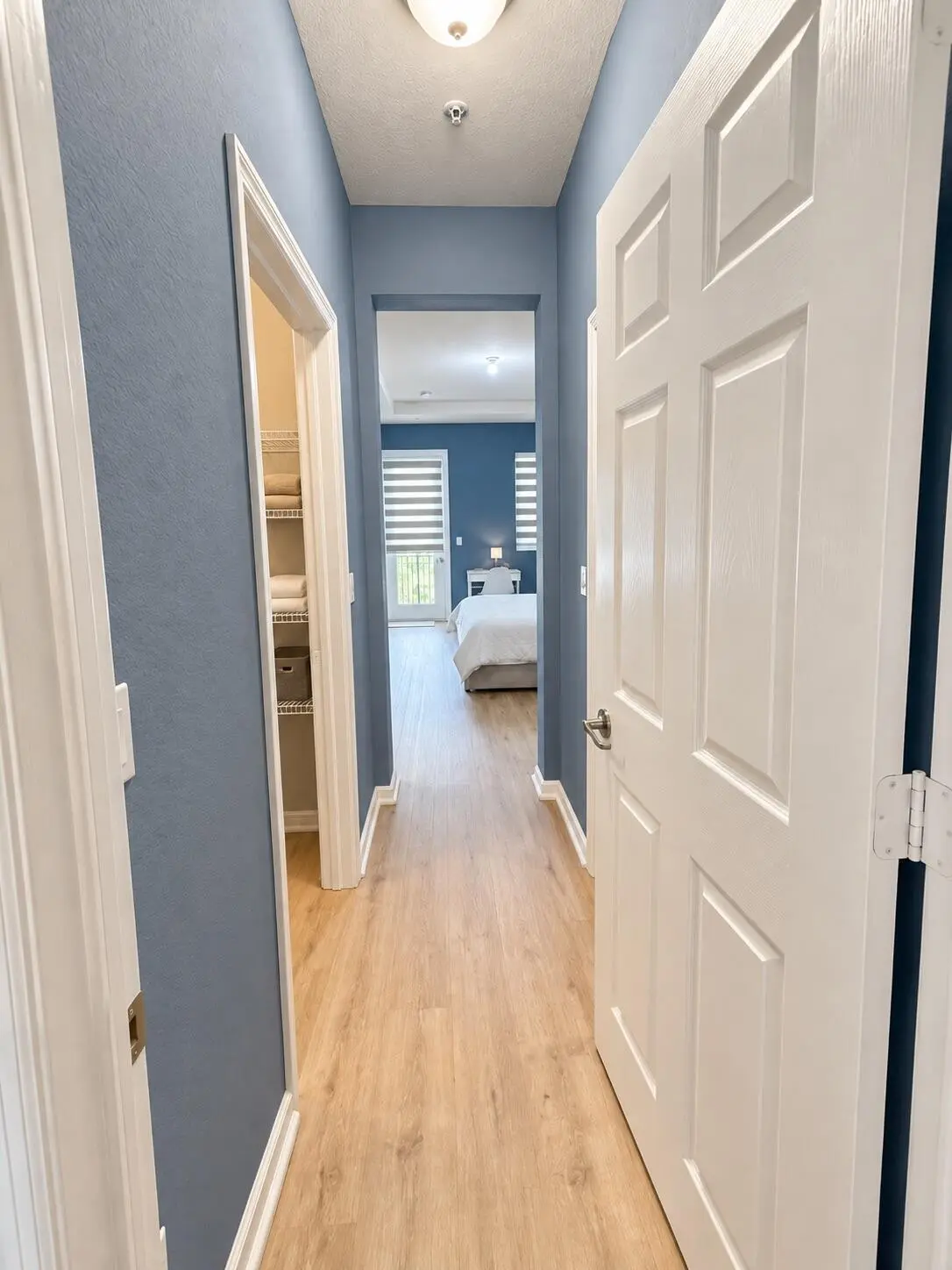 Bright blue-gray primary bedroom entry at 4618 Monarch Way, Coconut Creek