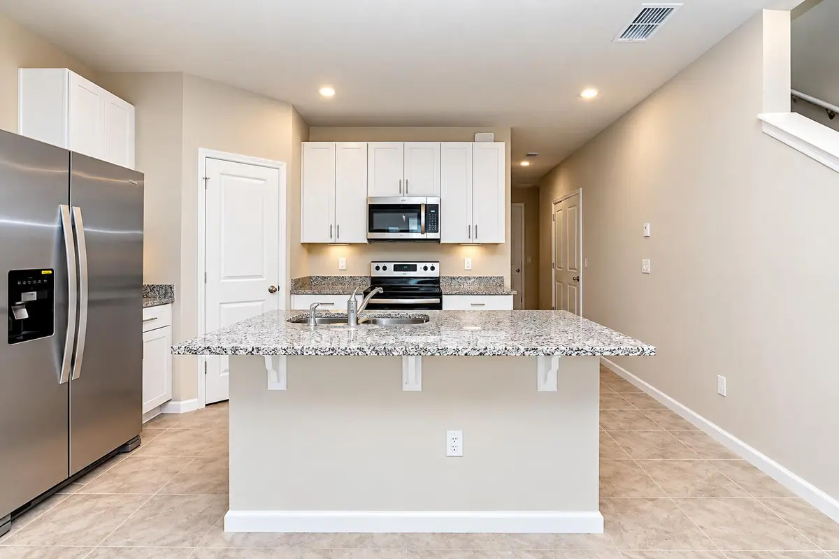 Modern Kitchen with Granite Island Sink at 5648 MENTMORE Drive, Mangonia Park