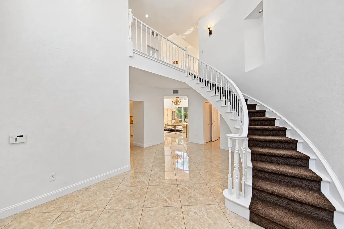 Wall niche and beautiful staircase at 7756 Travelers Tree Drive, Boca Raton