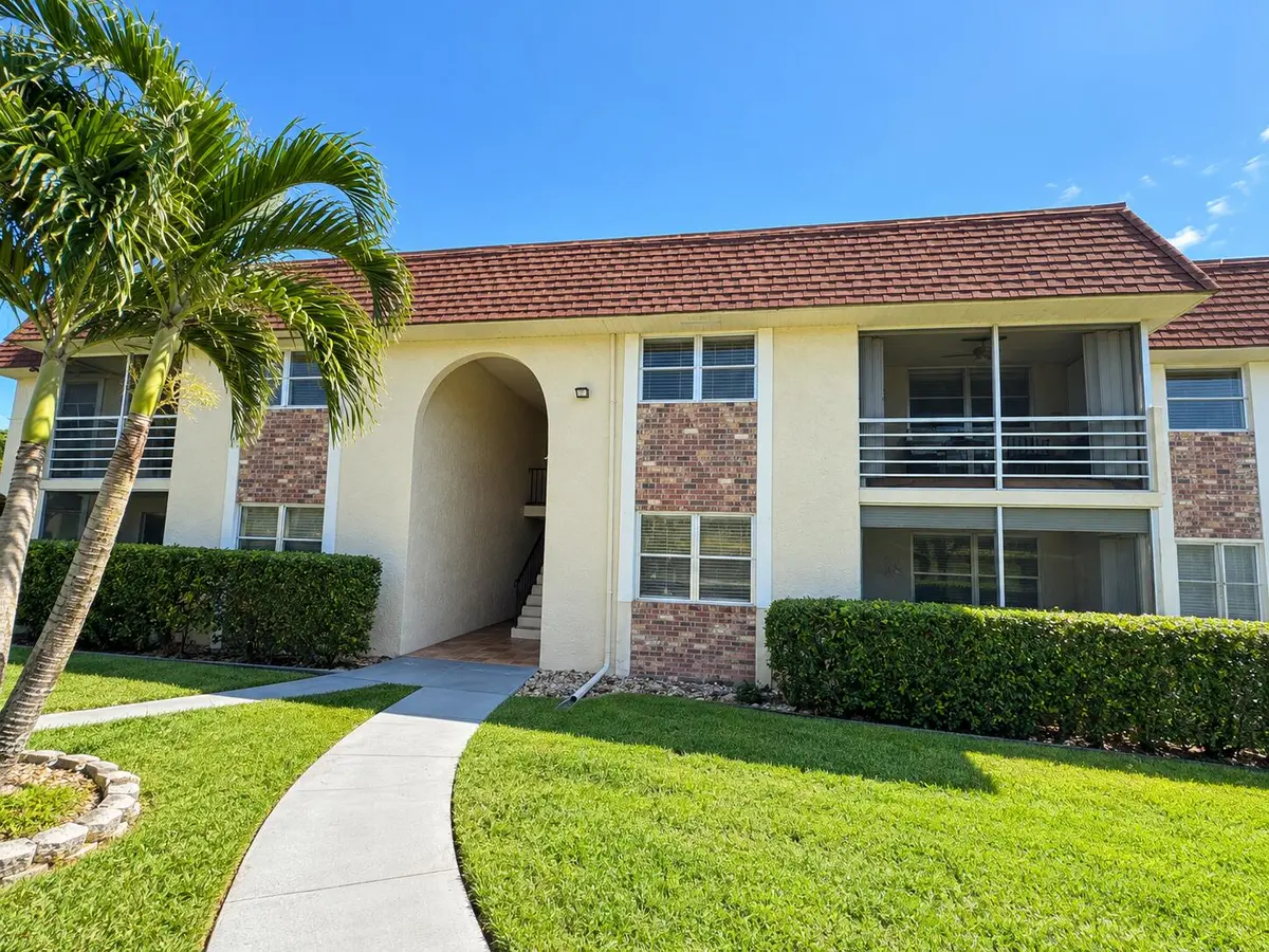 Sunny Condo Entrance with Tropical Lands at 22765 SW 66TH Avenue 104, Boca Raton