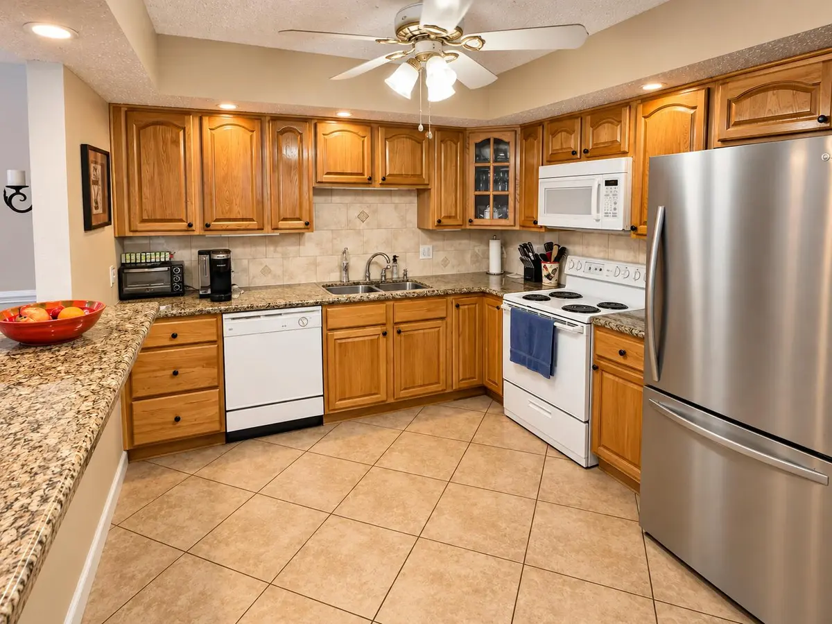 Warm Oak and Granite Kitchen Interior at 22765 SW 66TH Avenue 104, Boca Raton