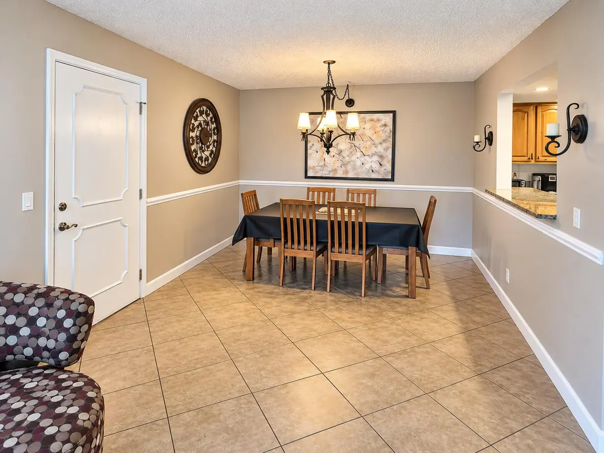 Warm Neutral Dining Room with Chandelier at 22765 SW 66TH Avenue 104, Boca Raton