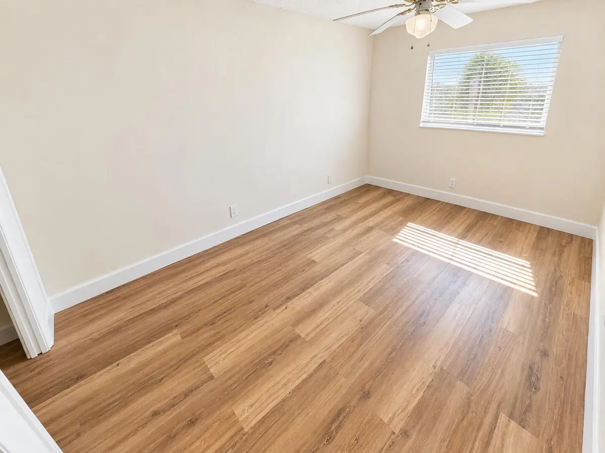 Bright Empty Bedroom with Wood Floors at , Boca Raton