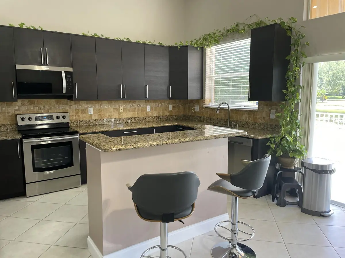 Lago kitchen with bar stools at 9514 Lago Drive, Boynton Beach