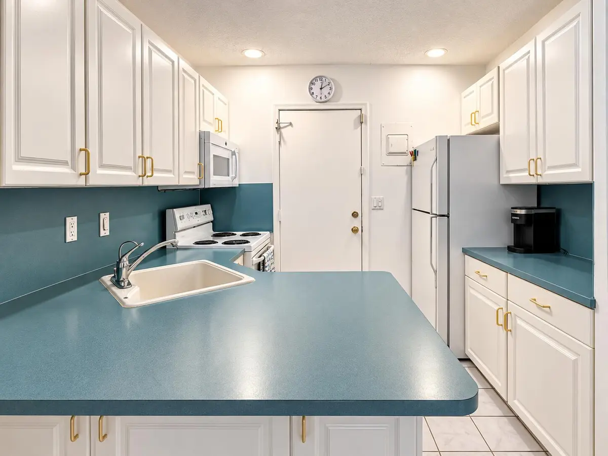 Bright Teal and White Galley Kitchen at 6263 NE 19TH Avenue 1005, Fort Lauderdale