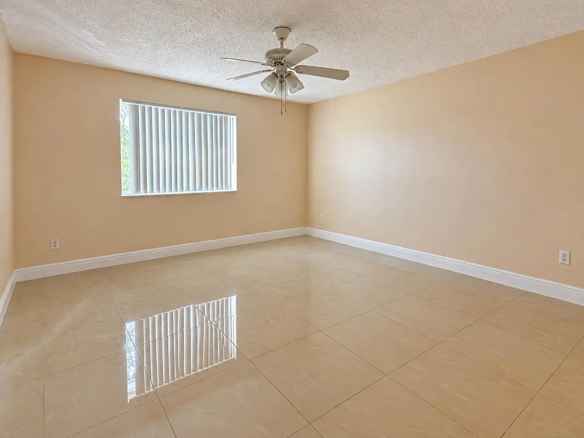 Bright Empty Room with Reflective Tile F at 2620 S UNIVERSITY Drive 311, Davie