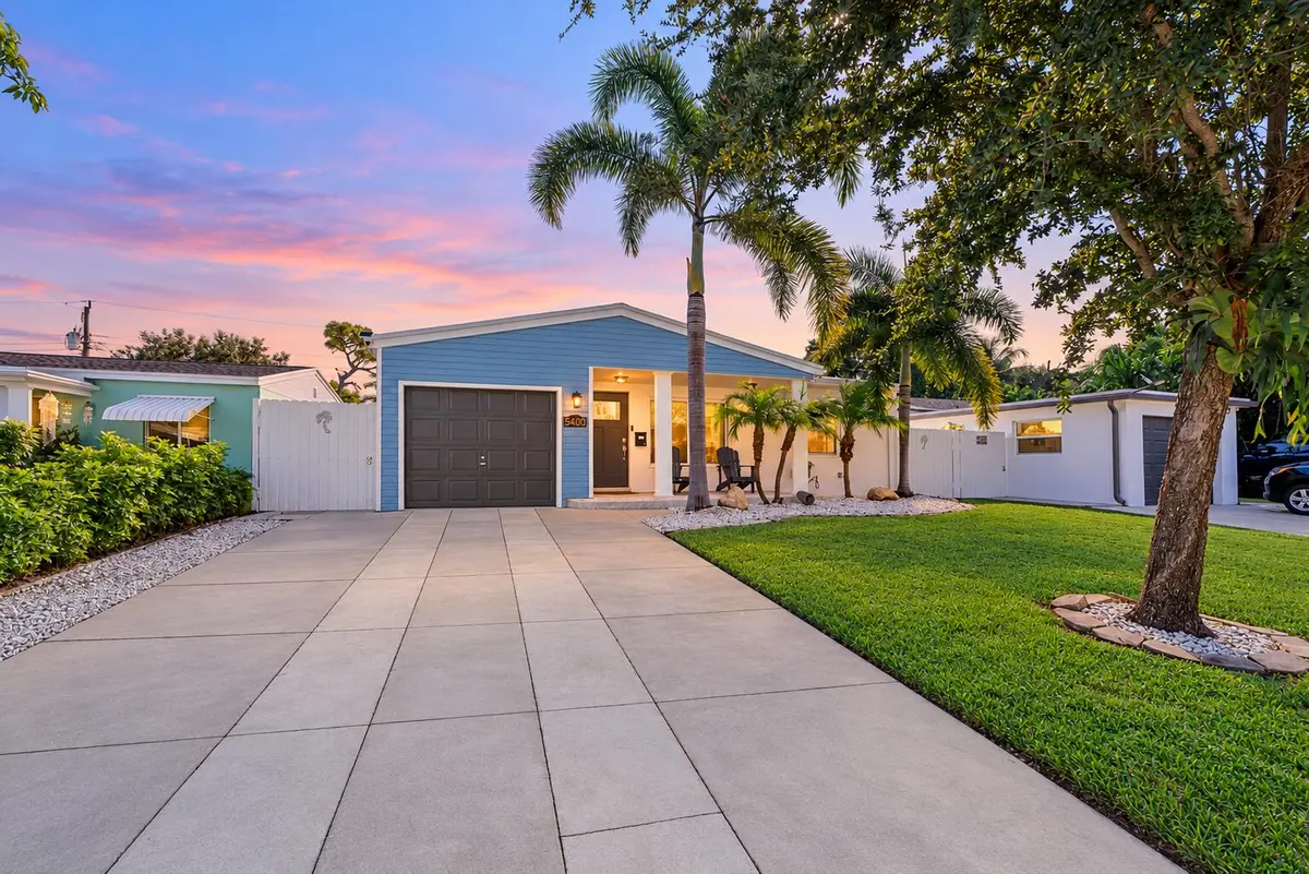 Bright twilight home with clean driveway at 5400 NE 4TH Terrace, Oakland Park