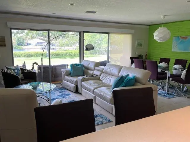 Living room view from kitchen at 9130 SE RIVERFRONT Terrace I, Jupiter