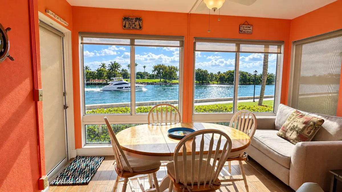 Luminous Waterfront Dining Room with Pas at 2 COLONIAL CLUB Drive 101, Boynton Beach
