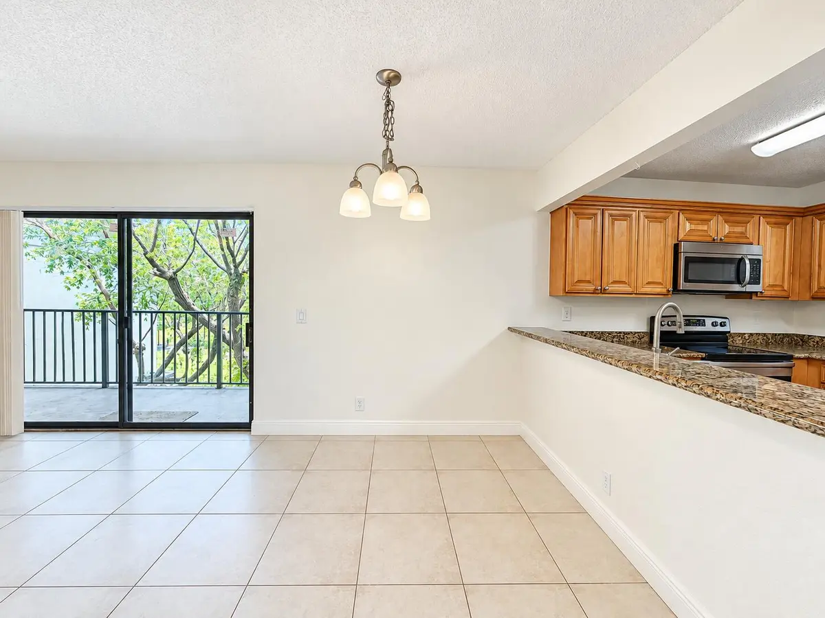 Bright Open Dining Area with Kitchen Vie at 1541 WINDORAH Way E, West Palm Beach