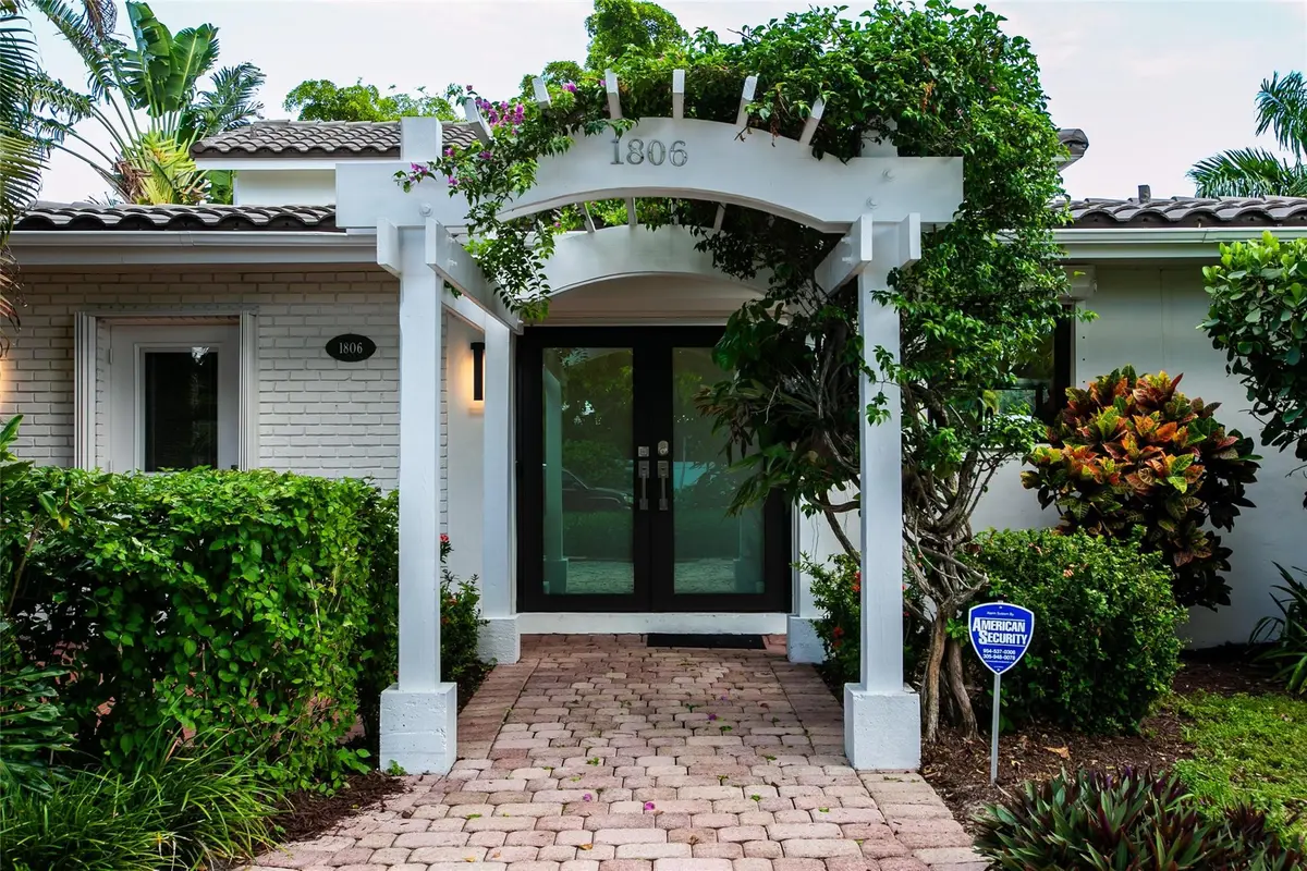 Trellis entry with impact French doors at 1806 NE 22ND Terrace, Fort Lauderdale