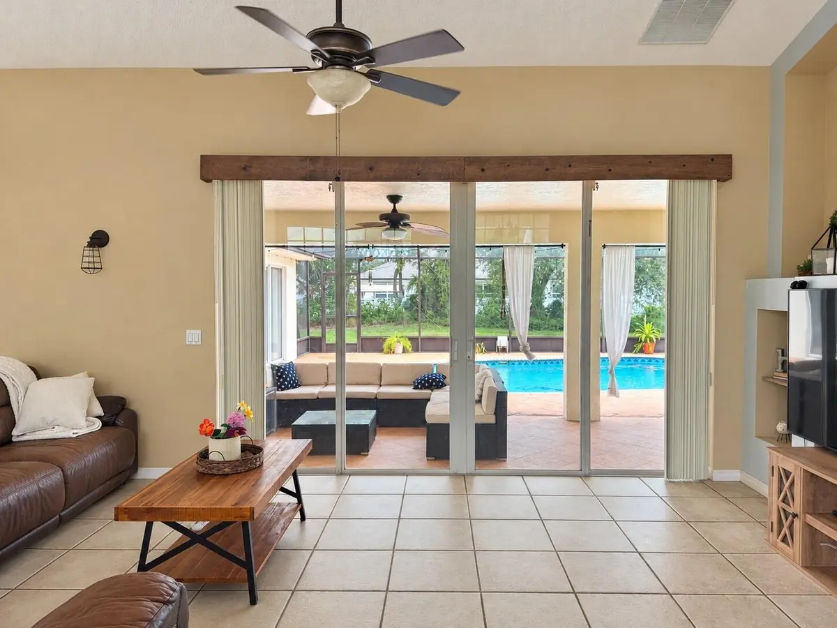 01-Living-Room-and-Pool-View at 194 SW Voltair Terrace, Port St. Lucie