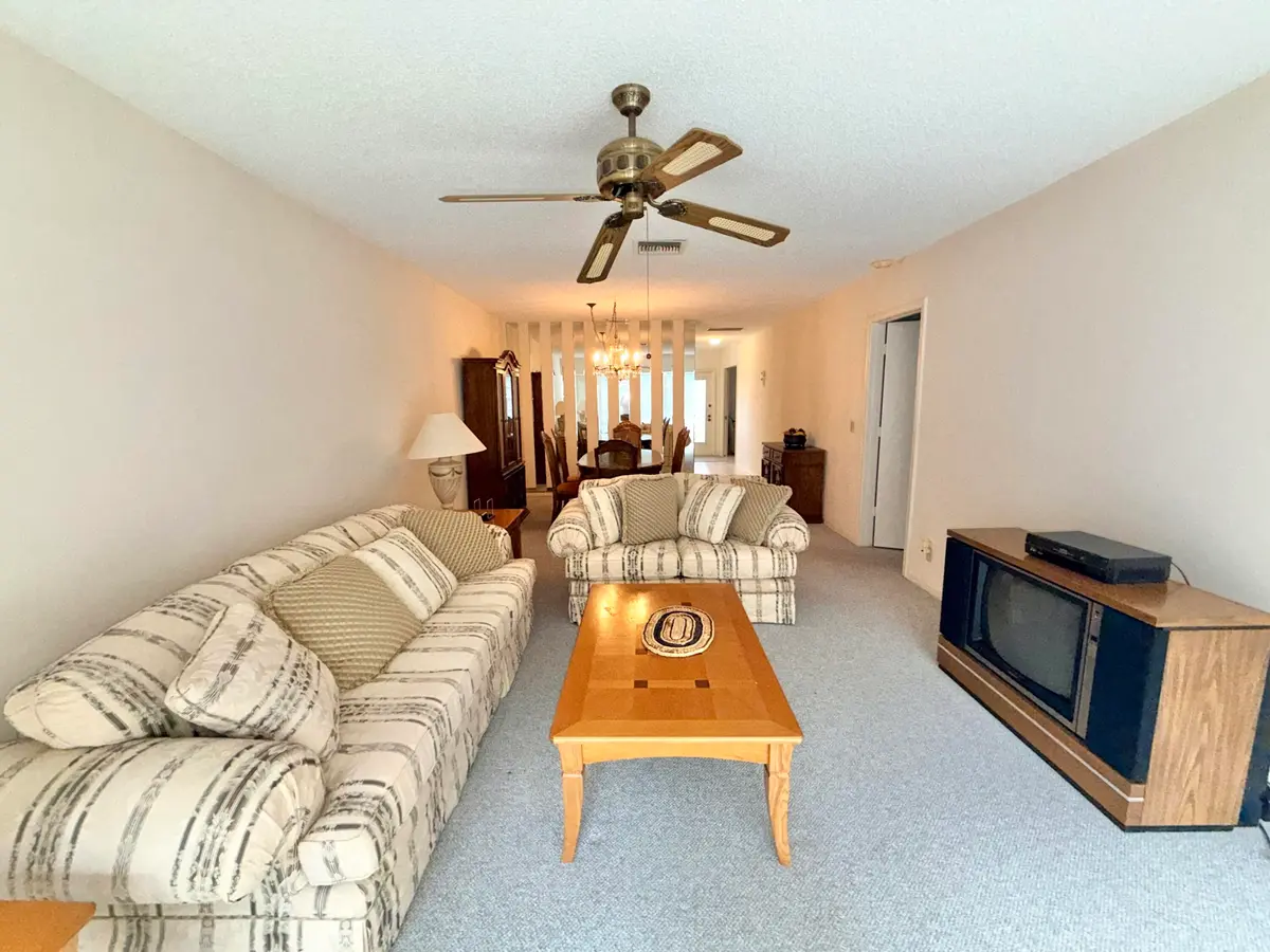 Living room to dining area at 1150 Mahogany Way 203, Delray Beach