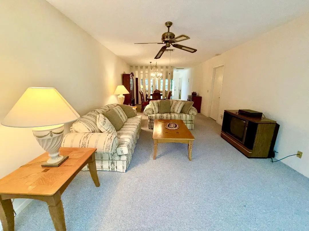 living room to dining area at 1150 Mahogany Way 203, Delray Beach