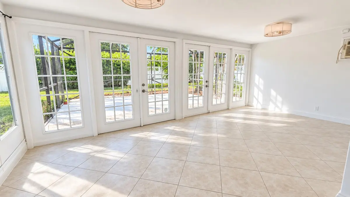 Sunlit Modern Sunroom with French Doors at 1288 SW 7th Street, Boca Raton