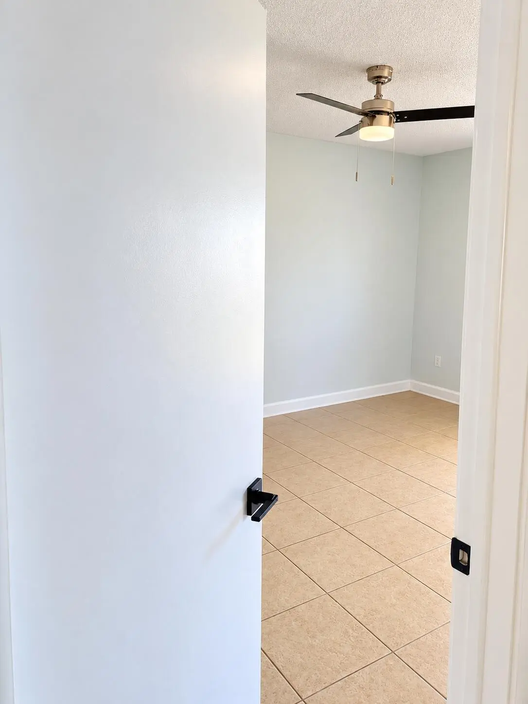 Minimalist Empty Room Through Doorway at 18286 MEDITERRANEAN Boulevard 202, Hialeah