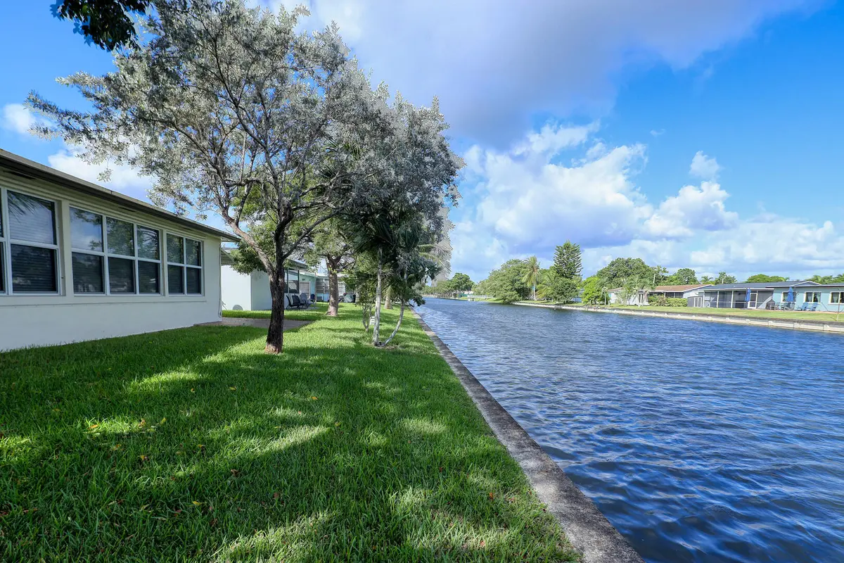 Wide Canal Views and Mature Trees at 7305 NW 58TH Court, Tamarac