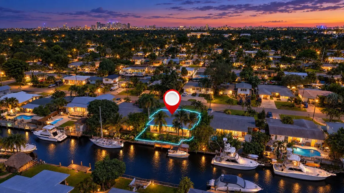 Twilight canal neighborhood with glowing at 2449 KEY LARGO Lane, Fort Lauderdale