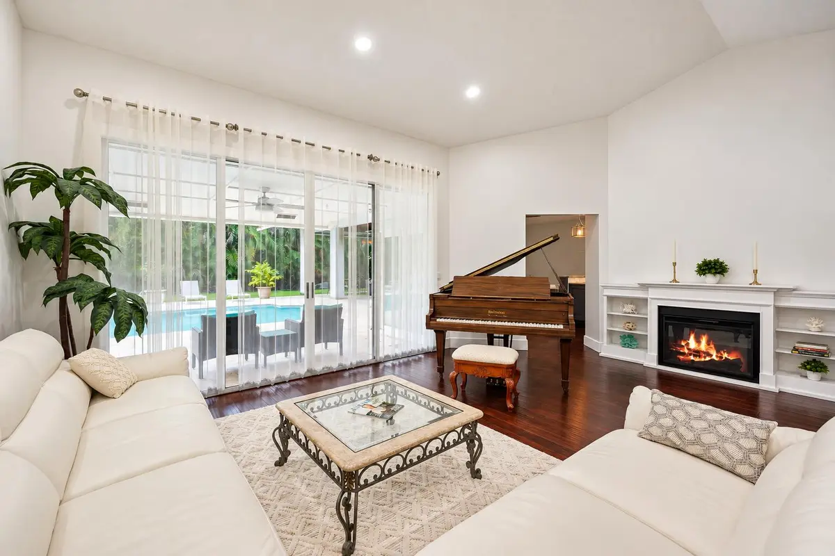Elegant Living Room with Piano and Pool at 18274 SE Ridgeview Drive, Jupiter