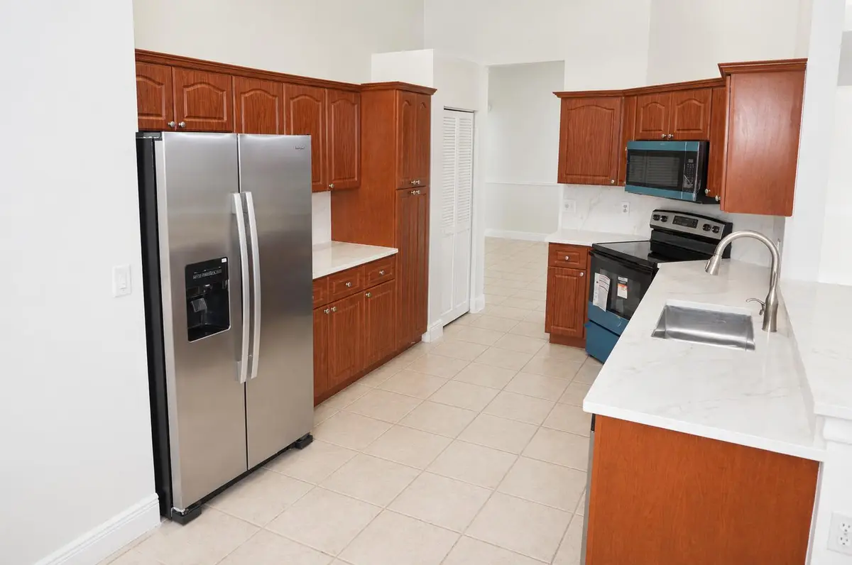 Bright Modern Kitchen with Warm Wood Cab at 4270 CAMROSE Lane, West Palm Beach