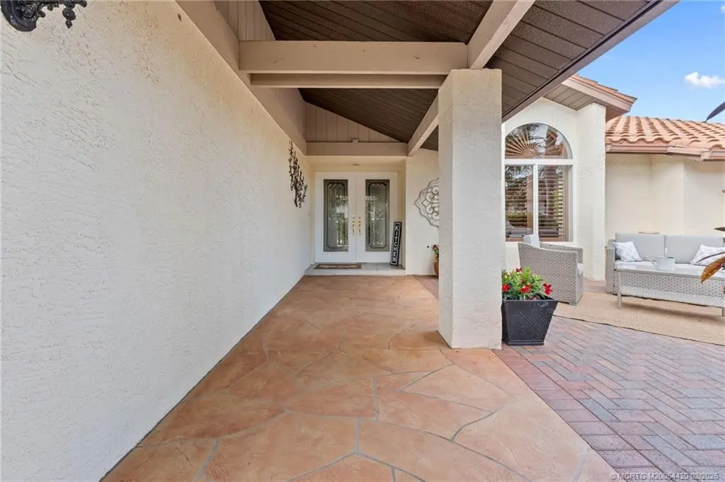Covered walkway to front door at 1828 SE Coronado Lane, Stuart