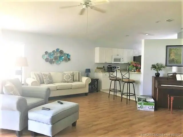Large living room with vaulted ceiling at 3486 SW Pindo Palm Lane, Palm City